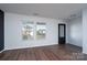 Bright living room showcasing luxury vinyl flooring, large windows, and a stylish front entry door at 310 Foster Ln, Albemarle, NC 28001