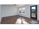 Spacious room featuring luxury vinyl plank flooring, ample sunlight, and a door leading to the backyard at 310 Foster Ln, Albemarle, NC 28001