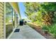 A patio view of a backyard with mature trees, a grill, and a lush yard at 4006 Trinity Ct, Indian Land, SC 29707