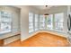 Sunny dining nook with hardwood floors, large windows, and a stylish pendant light at 4006 Trinity Ct, Indian Land, SC 29707