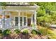 Inviting covered front porch with white columns, bay window, and a charming front door with decorative wreath at 4006 Trinity Ct, Indian Land, SC 29707