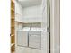 A functional laundry room featuring a washer, a dryer, and shelves for storage at 4006 Trinity Ct, Indian Land, SC 29707