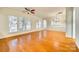 Bright living room featuring large windows, hardwood floors and a ceiling fan at 4006 Trinity Ct, Indian Land, SC 29707