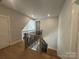 Upstairs hallway with hardwood floors and black metal staircase at 4356 Morning Mist Dr # 22, Sherrills Ford, NC 28673