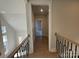 Upstairs hallway with hardwood floors and black metal staircase at 4356 Morning Mist Dr # 22, Sherrills Ford, NC 28673