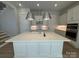 Bright kitchen boasts an island, pendant lighting, stainless steel appliances, and white cabinets at 4356 Morning Mist Dr # 22, Sherrills Ford, NC 28673