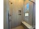 Modern shower with a built-in bench, niche, and neutral tiling at 4356 Morning Mist Dr # 22, Sherrills Ford, NC 28673