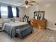 Comfortable bedroom with hardwood floors, ceiling fan, and dresser at 703 Margate Ave, Kannapolis, NC 28081