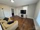 Living room with hardwood floors, couch, and TV at 703 Margate Ave, Kannapolis, NC 28081