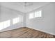 This bedroom features wood-look floors, a ceiling fan, bright white walls and natural light from the windows at 714 Barrel Aly, Fort Mill, SC 29715