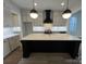 Modern kitchen with a large island, quartz countertops, and black cabinetry at 714 Barrel Aly, Fort Mill, SC 29715