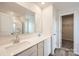 Bathroom featuring dual sinks, quartz countertop, large mirror and walk-in shower with clear glass door at 117 Dorian Pl, Troutman, NC 28166