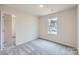 Clean bedroom offers soft carpet, a closet for storage, and a large window that brings in plenty of natural light at 117 Dorian Pl, Troutman, NC 28166