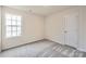 Neutral bedroom with soft carpet, bright window, and a closet, offering comfort and functionality at 117 Dorian Pl, Troutman, NC 28166