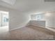 Large bonus room with neutral carpeting and a window at 117 Dorian Pl, Troutman, NC 28166