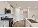 Well-equipped kitchen with stainless steel appliances, including gas range, modern sink and white subway tile backsplash at 117 Dorian Pl, Troutman, NC 28166