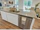 Kitchen island with granite countertop and stainless steel dishwasher at 117 Dorian Pl, Troutman, NC 28166