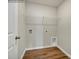 Laundry area with wood flooring, wire shelving and hookups at 117 Dorian Pl, Troutman, NC 28166