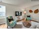 Living room with teal armchairs, a geometric coffee table, and a white media console at 117 Dorian Pl, Troutman, NC 28166