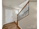 Elegant staircase with a metal railing leading to the upper level of the home at 117 Dorian Pl, Troutman, NC 28166