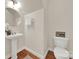 Clean bathroom with pedestal sink and hardwood floors at 1360 Barnett Woods, Fort Mill, SC 29708