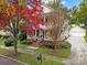 Two-story house with wrap-around porch and autumn foliage at 1360 Barnett Woods, Fort Mill, SC 29708