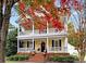 Two-story house with wraparound porch and brick steps, surrounded by fall foliage at 1360 Barnett Woods, Fort Mill, SC 29708