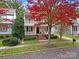 Two-story house with wrap-around porch and autumn foliage at 1360 Barnett Woods, Fort Mill, SC 29708