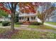 Two-story house with a brick walkway and landscaping; autumn leaves are scattered on the ground at 1360 Barnett Woods, Fort Mill, SC 29708