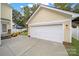 Detached garage with white door and exterior lights at 1360 Barnett Woods, Fort Mill, SC 29708