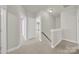 Upstairs hallway with neutral carpeting and doors to bedrooms at 1360 Barnett Woods, Fort Mill, SC 29708