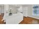 White kitchen with an island, hardwood floors, and stainless steel appliances at 1360 Barnett Woods, Fort Mill, SC 29708