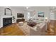 Virtually staged living room with hardwood floors and fireplace at 1360 Barnett Woods, Fort Mill, SC 29708