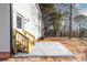 Backyard with a newly poured patio, wooden stairs and white siding on this new construction home at 150 Roxie Ln, Belmont, NC 28012