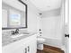 Bright bathroom features a granite-topped vanity, wood-look floors, and a shower over tub at 150 Roxie Ln, Belmont, NC 28012