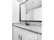 Bathroom featuring a large, framed mirror above a granite-topped vanity with black hardware at 150 Roxie Ln, Belmont, NC 28012