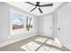 Bedroom filled with natural light has neutral carpet, large windows, and a modern ceiling fan at 150 Roxie Ln, Belmont, NC 28012