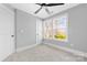 This bedroom features a window providing natural light, neutral carpet, and a ceiling fan at 150 Roxie Ln, Belmont, NC 28012