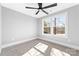 Bedroom filled with natural light has neutral carpet, large windows, and a modern ceiling fan at 150 Roxie Ln, Belmont, NC 28012