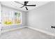 Bedroom with a large window offering nice views, neutral carpet and a modern ceiling fan at 150 Roxie Ln, Belmont, NC 28012