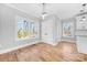 Open dining room with hardwood floors, three large windows and modern light fixture at 150 Roxie Ln, Belmont, NC 28012