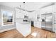 Bright kitchen with white cabinets, granite countertops, stainless steel appliances and hardwood floors at 150 Roxie Ln, Belmont, NC 28012