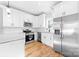 Modern kitchen featuring white cabinets, stainless steel appliances, and granite countertops at 150 Roxie Ln, Belmont, NC 28012