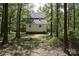 Backyard of a two-story home with a wooden deck surrounded by dense trees at 1062 Full Count Ln, Lancaster, SC 29720