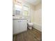 Bathroom featuring a white vanity, tub-shower combo, and hardwood floors at 1062 Full Count Ln, Lancaster, SC 29720