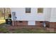 Exterior shot features the HVAC system, updated plumbing, white siding, and brick foundation at 1062 Full Count Ln, Lancaster, SC 29720