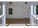 Front porch with white columns, a wood floor, and a simple exterior door at 1062 Full Count Ln, Lancaster, SC 29720