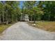 Charming two-story home with a long gravel driveway and wooded surroundings at 1062 Full Count Ln, Lancaster, SC 29720