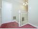 Hallway with carpeted stairs and white railing at 1062 Full Count Ln, Lancaster, SC 29720