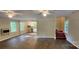 Open-concept living room with hardwood floors, ceiling fans, and adjacent kitchen area at 1062 Full Count Ln, Lancaster, SC 29720
